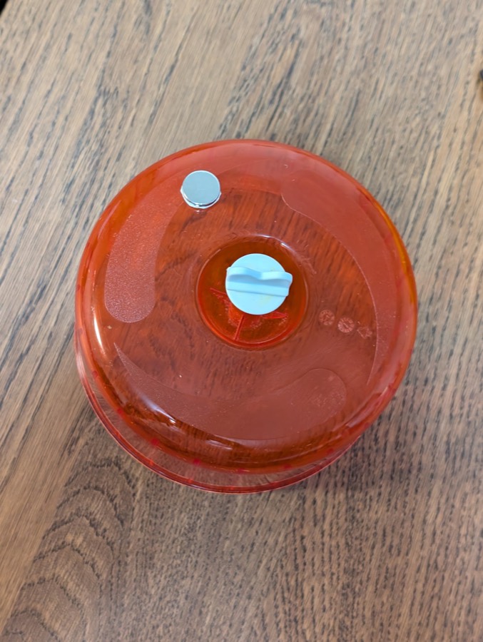 The neodymium magnet attached to the outside of the wheel, opposite the axle cap