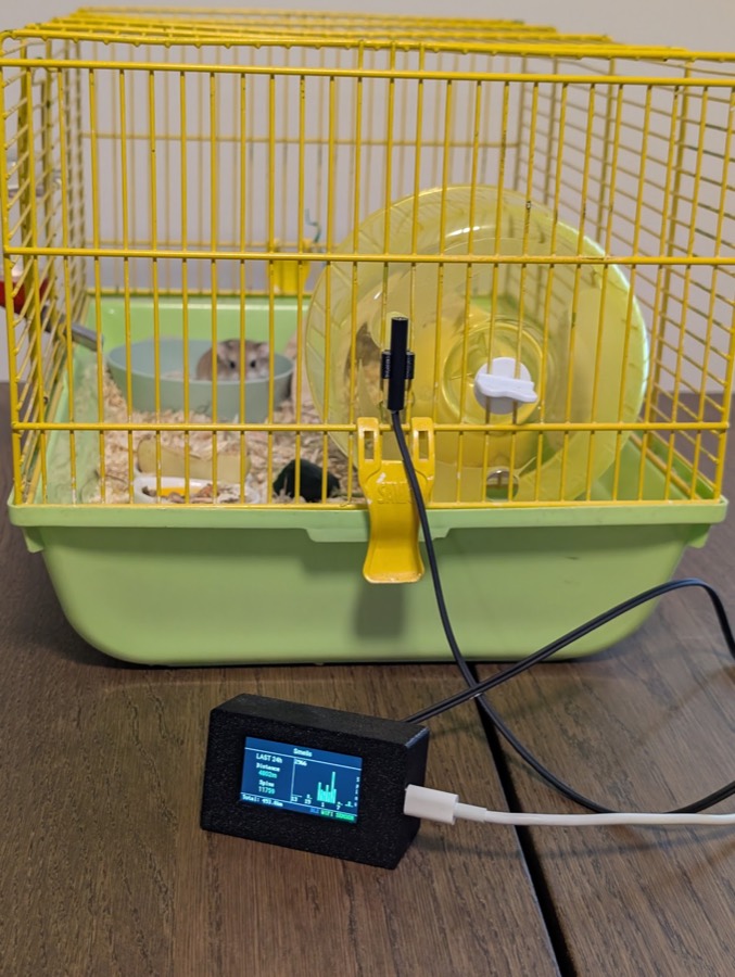 A finished setup: sensor and magnet on the wheel, cable running to the receiver, which shows live distance, spin count and an hourly chart
